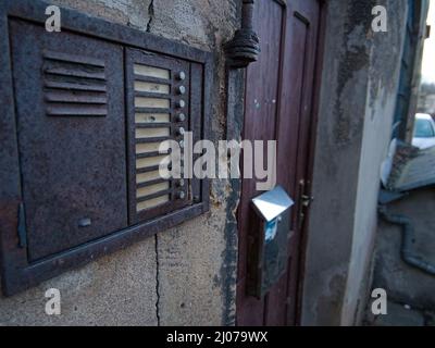 a close up of a old intercom in brick building Stock Photo