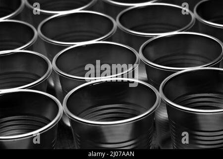 Close up of many empty translucent plastic cups, ordered in rows. Shallow depth of field. Intentionally underexposed. Abstract background, environment Stock Photo