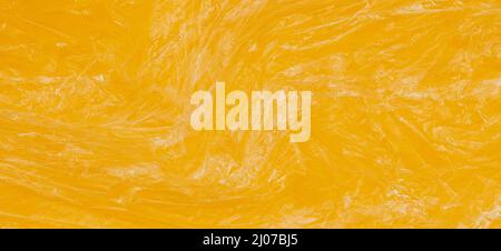 Crumpled wrinkled plastic transparent plastic cellophane wrapper on yellow color background. Abstract creative texture banner background Stock Photo
