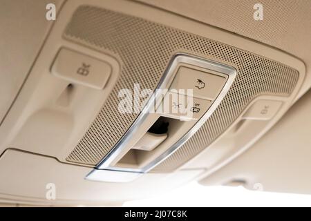Closeup of cabin lights switch in car, light control panel inside a car interior. For reading etc. Stock Photo