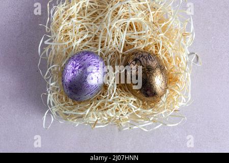 Decorated and painted easter eggs in straw nest Stock Photo
