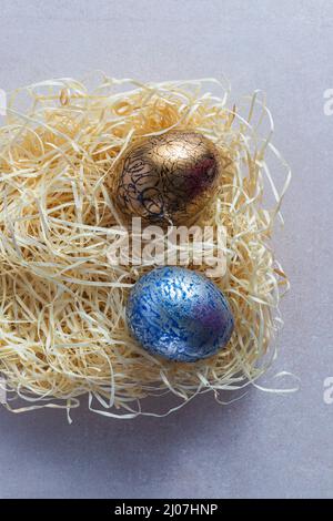 Decorated and painted easter eggs in straw nest