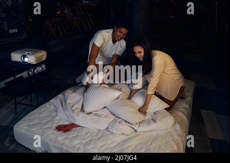 Couple attack bloody hand in bed with pillow Stock Photo
