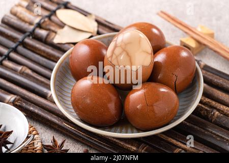 Close up of delicious traditional Taiwanese famous food tea eggs with in a bowl on gray table background. Stock Photo