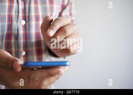 Close up of young man hand using smart phone. Stock Photo