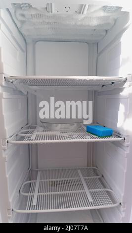 Defrosting of the home freezer. Freezer maintenance, defrosting, washing, repair. Stock Photo