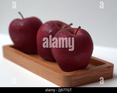Apple on wooden box or plate and white background close up photo Stock Photo