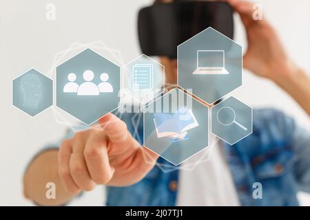 Young woman touch virtual hologram with non-fungible token hud, lines and art image icons. Glowing lines and blocks with nft symbol. Concept of Stock Photo