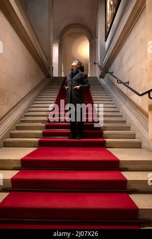Woman Standing on Red Carpet in Switzerland. *** Local Caption ***  standing,red carpet,carpet,red,arch,stairs,stracase,steps,cross,woman,one woman,on Stock Photo