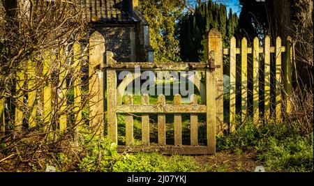 An old oak gate leading to St Mary's Church, a Church of England Parish church in Wortham, Norfolk, UK. Wortham church has the biggest round tower in Stock Photo