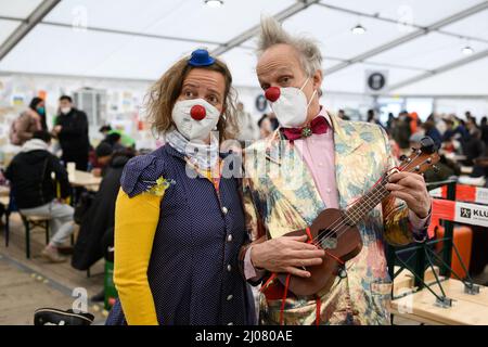 Berlin, Germany. 17th Mar, 2022. Clowns Maria and Filou from the 'red noses' make their jokes for the children who have fled from Ukraine in the welcome tent at Berlin's main train station. Every day, several thousand people arrive at the train station in the German capital and the number of refugees from Ukraine is expected to continue rising. Credit: Bernd von Jutrczenka/dpa/Alamy Live News Stock Photo