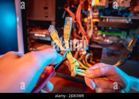 Cutting the Internet cable tied into a knot with wire cutters. The concept of disconnecting the Internet and restricting access to resources Stock Photo