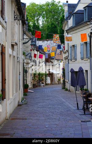 AZAY-LE-RIDEAU, FRANCE -24 JUN 2021- Street view of the village of Azay-le-Rideau, home of a landmark Renaissance castle, with suspended fabric lanter Stock Photo