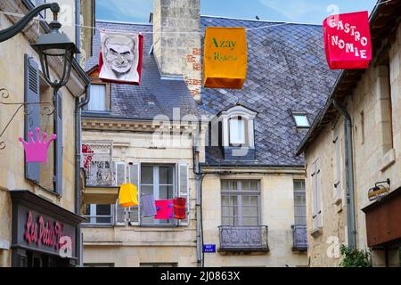 AZAY-LE-RIDEAU, FRANCE -24 JUN 2021- Street view of the village of Azay-le-Rideau, home of a landmark Renaissance castle, with suspended fabric lanter Stock Photo