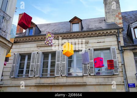 AZAY-LE-RIDEAU, FRANCE -24 JUN 2021- Street view of the village of Azay-le-Rideau, home of a landmark Renaissance castle, with suspended fabric lanter Stock Photo