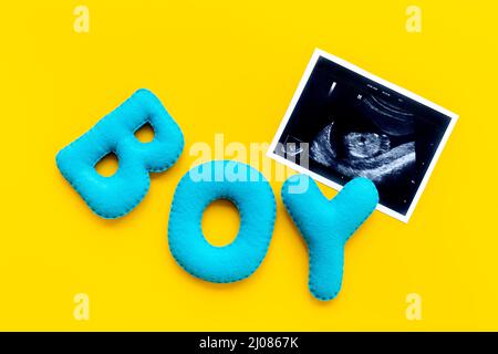 Ultrasound scan of unborn baby with letters boy Stock Photo