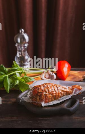 Artisan ham made from turkey meat, boiled and smoked with the addition of chicken fillet in a polyethylene vacuum packaging. Stock Photo