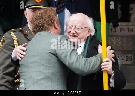 American-Irish actor John C. Reilly (centre) and President Michael D higgins during the St Patrick's Day Parade in Dublin, which has returned in full, with crowds on the streets of Dublin after Covid-19 put a pause on celebrations for the last two years. Picture date: Thursday March 17, 2022. Stock Photo