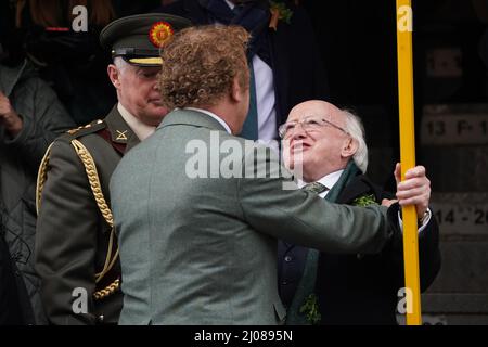 American-Irish actor John C. Reilly (centre) and President Michael D higgins during the St Patrick's Day Parade in Dublin, which has returned in full, with crowds on the streets of Dublin after Covid-19 put a pause on celebrations for the last two years. Picture date: Thursday March 17, 2022. Stock Photo