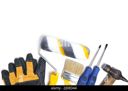 Set tools for home repair and wall painting. Gloves, paint roller, brush hammer and screwdrivers on white background Stock Photo