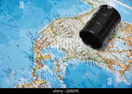 Oil drum with crude petroleum lying on a map Stock Photo