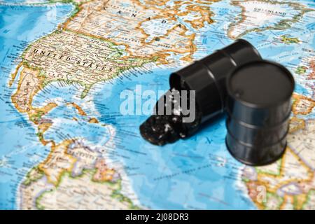 Oil drums spilling oil to the map Stock Photo