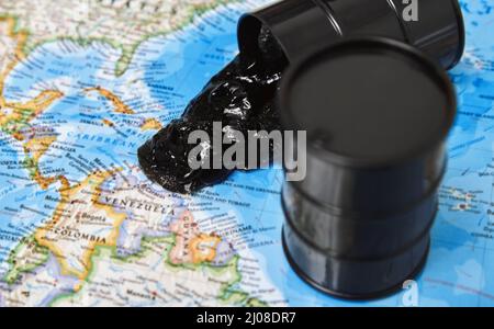 Oil drums spilling oil to the map Stock Photo