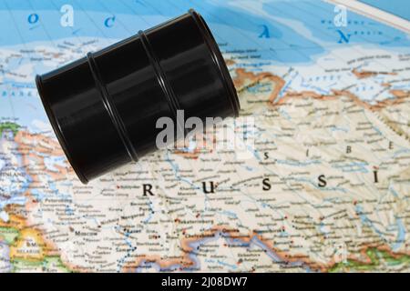 Oil drum with crude petroleum lying on a map Stock Photo