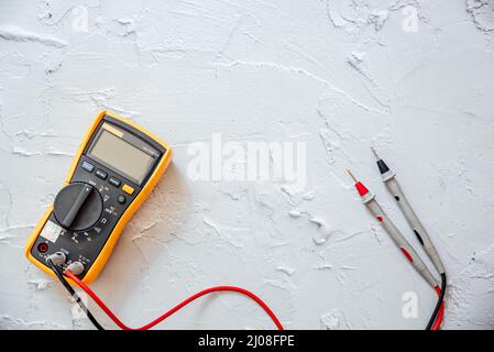 Yellow Digital multimeter with probes on white background with free copy space. Stock Photo