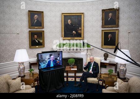 Washington DC, USA. 17th Mar, 2022. U.S. President Joe Biden (R) and Ireland's Prime Minister Micheal Martin (L) meet virtually in the Oval Office of the White House in Washington, DC on Thursday, March 17, 2022. Martin tested positive for Covid-19 while in Washington for St. Patrick's Day celebrations. Photo by Al Drago/UPI Credit: UPI/Alamy Live News Stock Photo