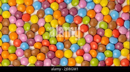 Photophone, candies of different colors in the form of tiles, decorative tiles made of chocolates. Stock Photo