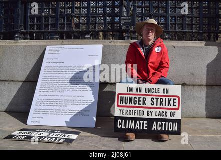 London, UK. 17th Mar, 2022. A man by the name of Angus Rose has begun a hunger strike outside the UK Parliament to pressure the government into taking action on climate change. According to the protester, the Prime Minister received a secret briefing in 2020 from the Chief Scientific Advisor on the risks of, and solutions to, the climate crisis, and is asking the PM to make this briefing public. Credit: ZUMA Press, Inc./Alamy Live News Stock Photo