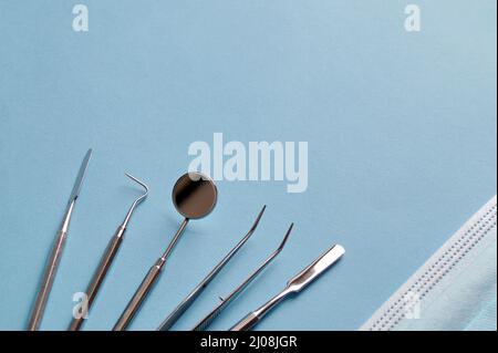 there are dental brushes and devices and a face mask on the table Stock Photo
