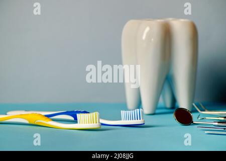 on the table in front of the tooth there are toothbrushes and devices for dental treatment Stock Photo