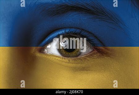 Face of little boy painted in colors of Ukrainian flag, closeup Stock Photo