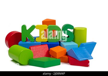 Wooden building blocks of different shapes and colors against a white background Stock Photo