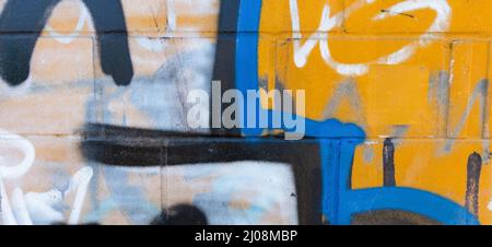 Fragment of colorful graffiti drawing made with aerosol paints on white brick wall Stock Photo