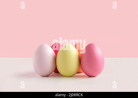 Easter banner with colorful Easter Egg in a row. Border over a yellow background. Above view with copy space. Happy Easter card. Front view Stock Photo