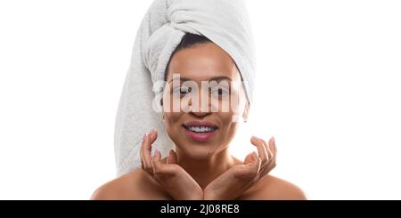 Smiley 35 years old african-american woman after shower with terry towel on head - isolated on white background. She looking at camera and smiling. Fo Stock Photo