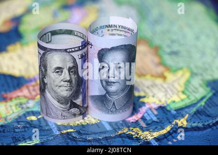 Chinese yuan and US dollars on the map of China. Concept of political conflict over Taiwan Stock Photo