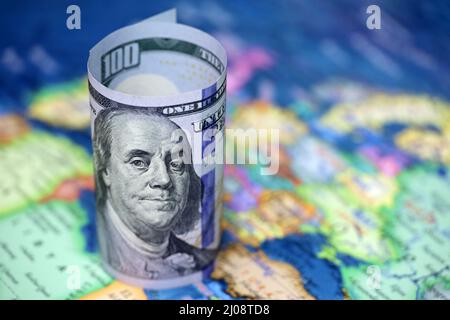 US dollars on background of political map of Europe. Concept of trade between the United States and European Union, exchange rate, tourism Stock Photo