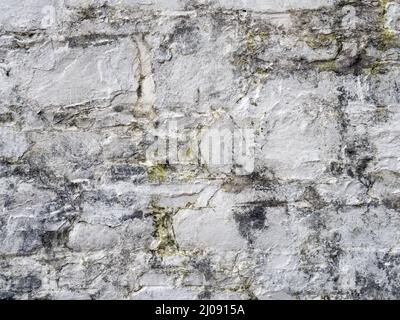 Old white, painted stone wall background. Stock Photo
