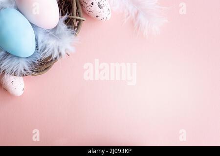 Stylish Frame of pale pink and blue Easter eggs with copy space for your text. Flat lay Stock Photo