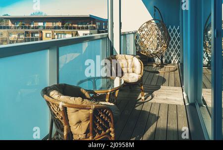 Modern large balcony with furniture on the top floor. Stock Photo