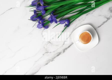 Cup of hot morning coffee and violet irises on marble background. Flat lay with copy space for text. Greeting card for Women's Day and March 8th. Stock Photo