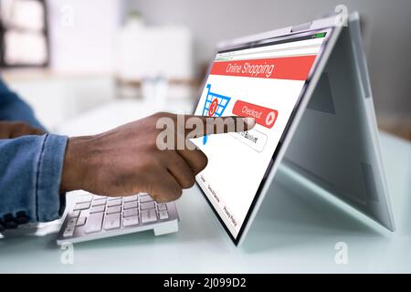 Close-up Of A Man Doing Online Shopping On Laptop Stock Photo
