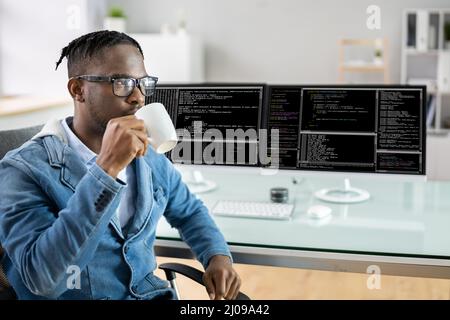 Computer Programmer Writing Program Code On Computer In Office Stock Photo