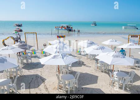 Maragogi, AL, Brazil - October 17, 2021: view to the beach umbrellas in front of Marazul restaurant on Barra Grande beach during morning. Stock Photo