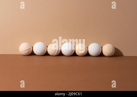 The organic bath bombs with shadow on beige background. Spa concept. Presents for body. Space for text. Stock Photo