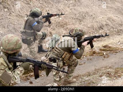 Soldiers during combat. Ukrainian soldiers with assault rifle take part ...